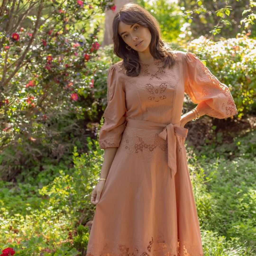 Woman wearing the nouveau midi dress in blush pink