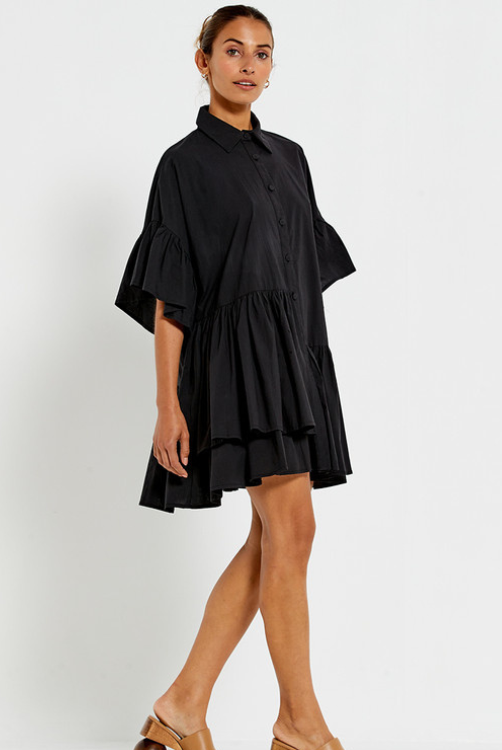 Model wearing the Bohemian Traders black Genoa Dress with button up front