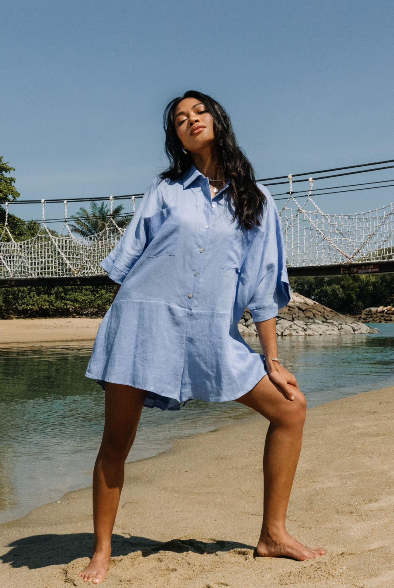 Pixie Cornflower blue playsuit with shell buttons and a stand collar