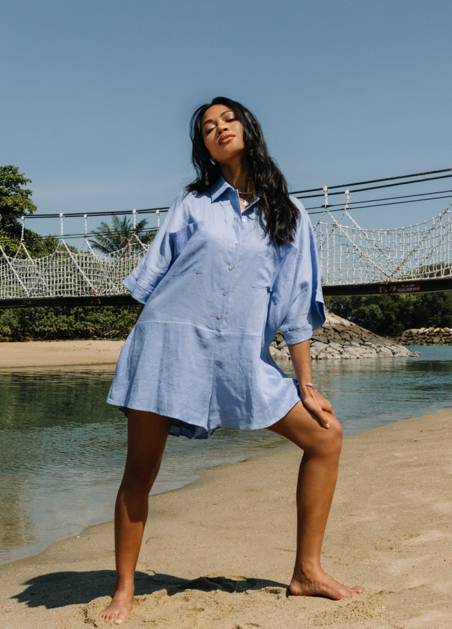 Pixie Cornflower blue playsuit with shell buttons and a stand collar