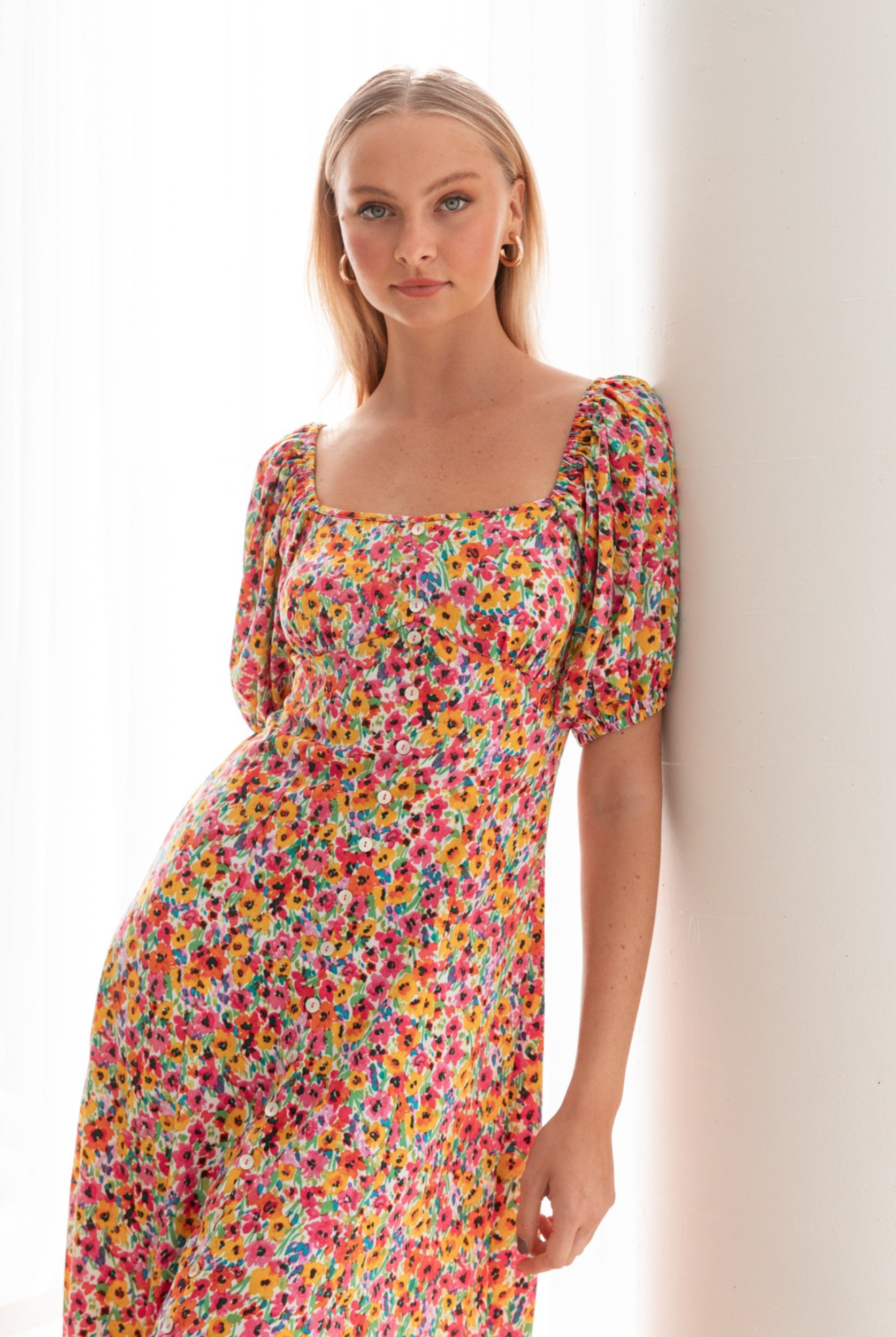 Model wearing the floral print Lucia Dress from Paper Heart