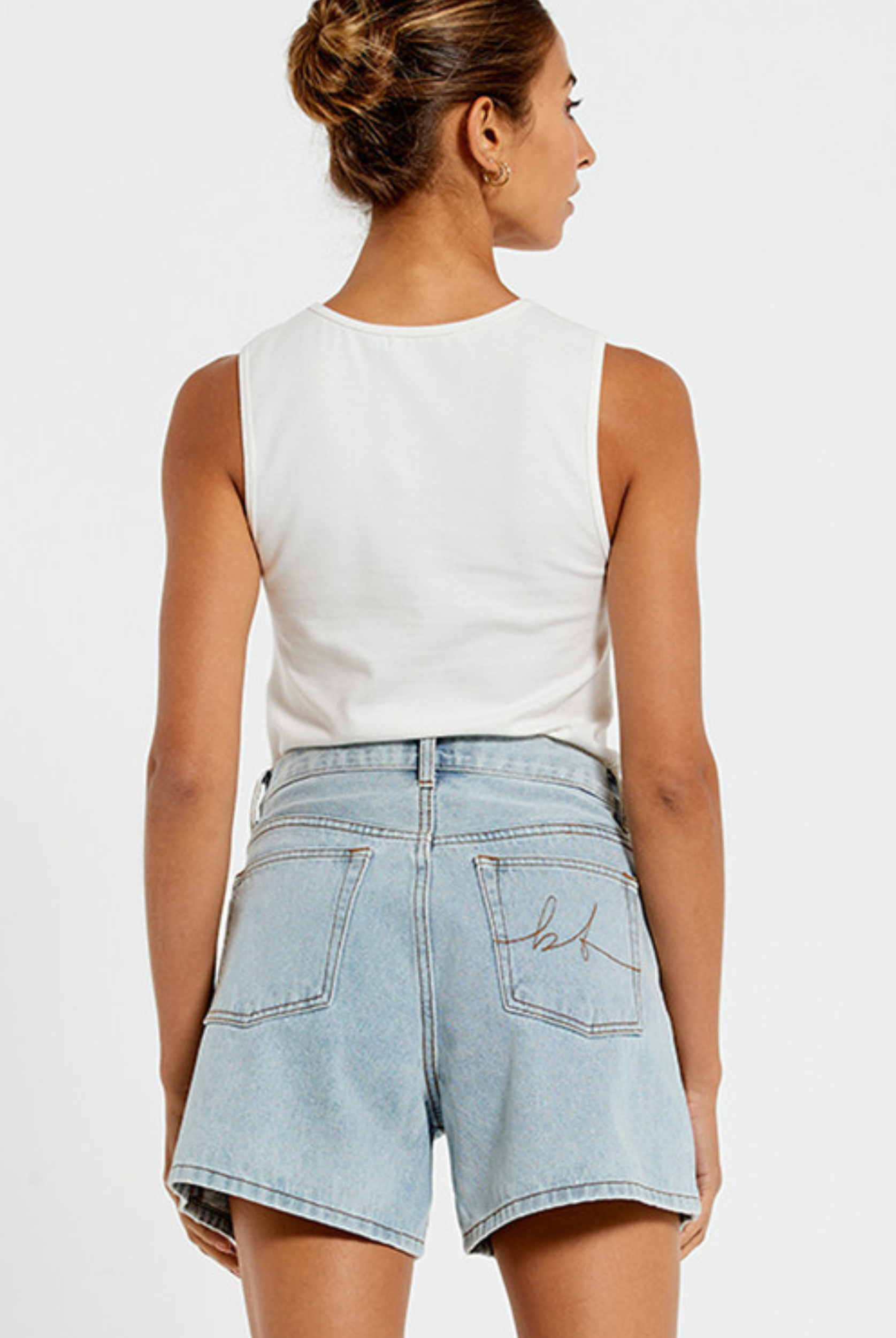 Model wearing the Bohemian Traders Mid Thigh ice wash short