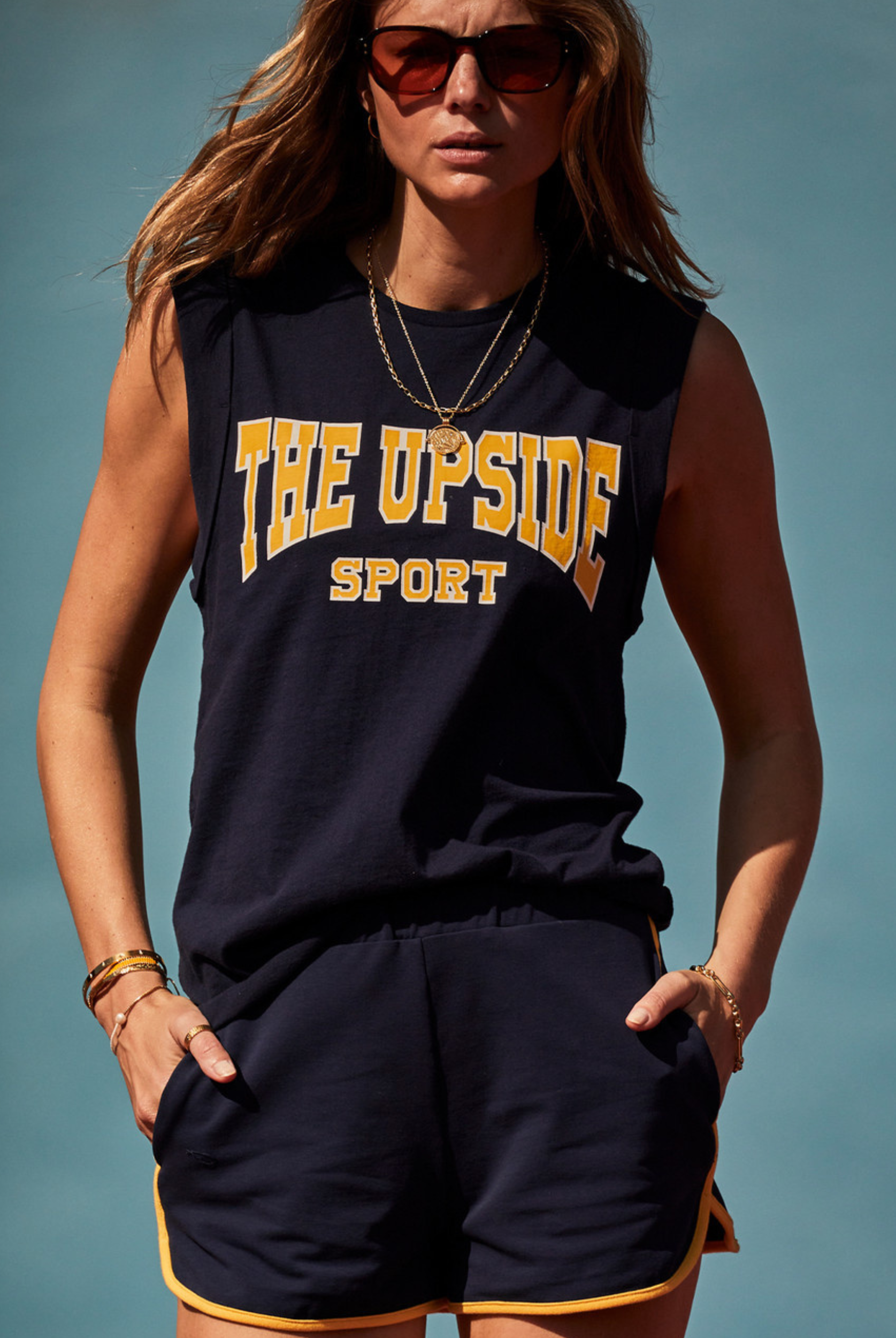 The Upside Ivy Leage Tank in navy with yellow and white logo design