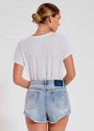 Distressed mid wash short with button closure