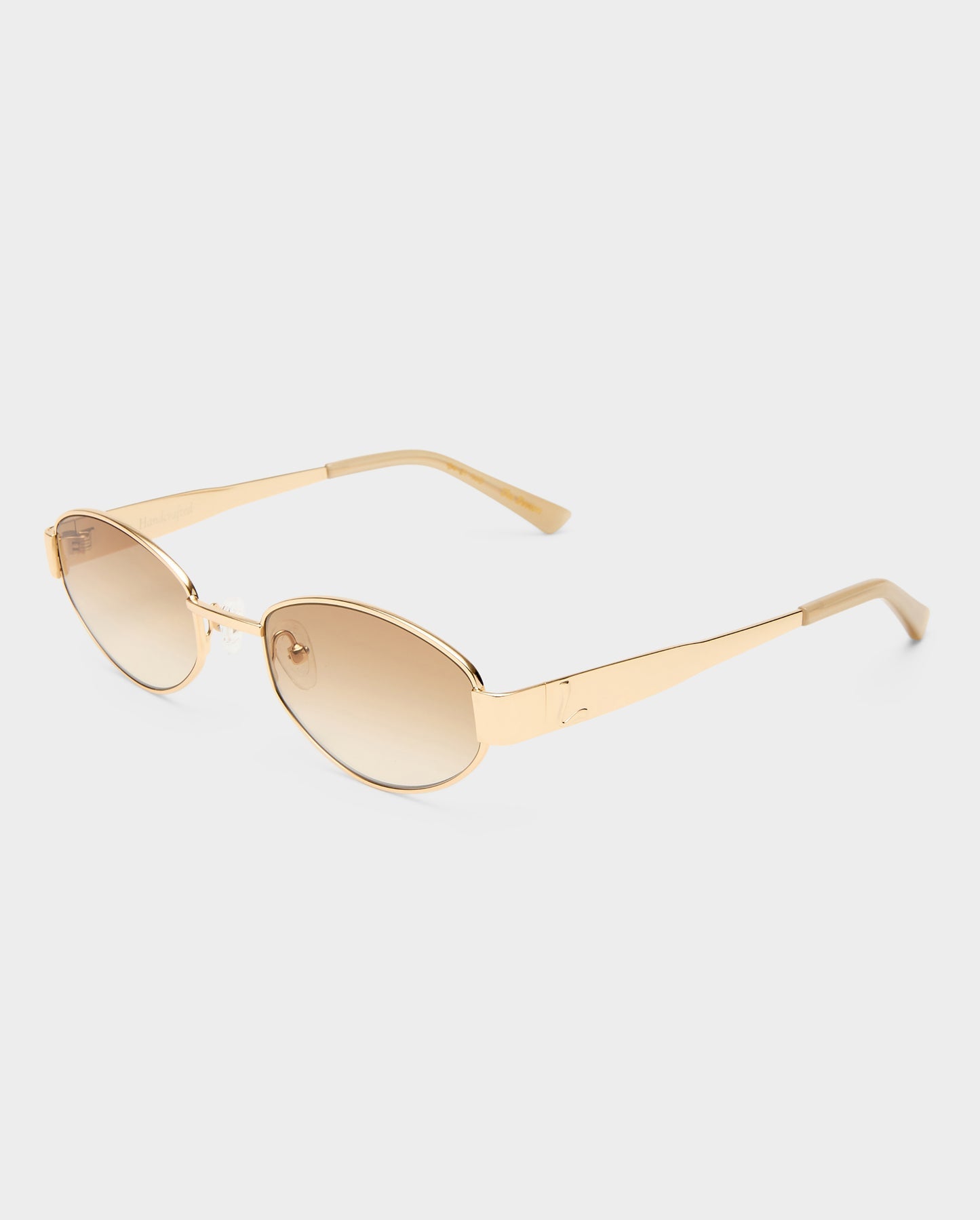 Gold-framed sunglasses with gold lenses on a white background