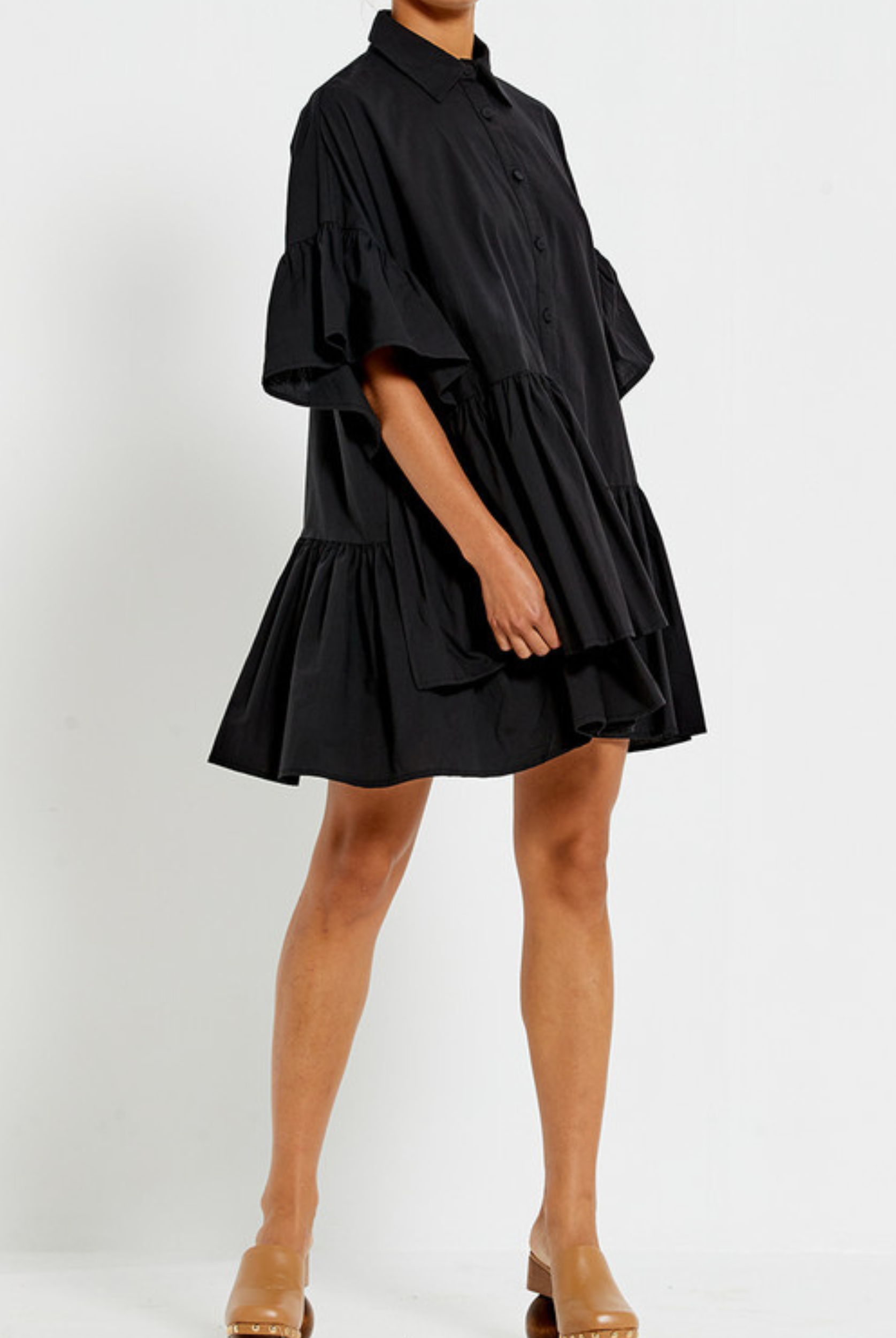 Model wearing the Bohemian Traders black Genoa Dress with button up front