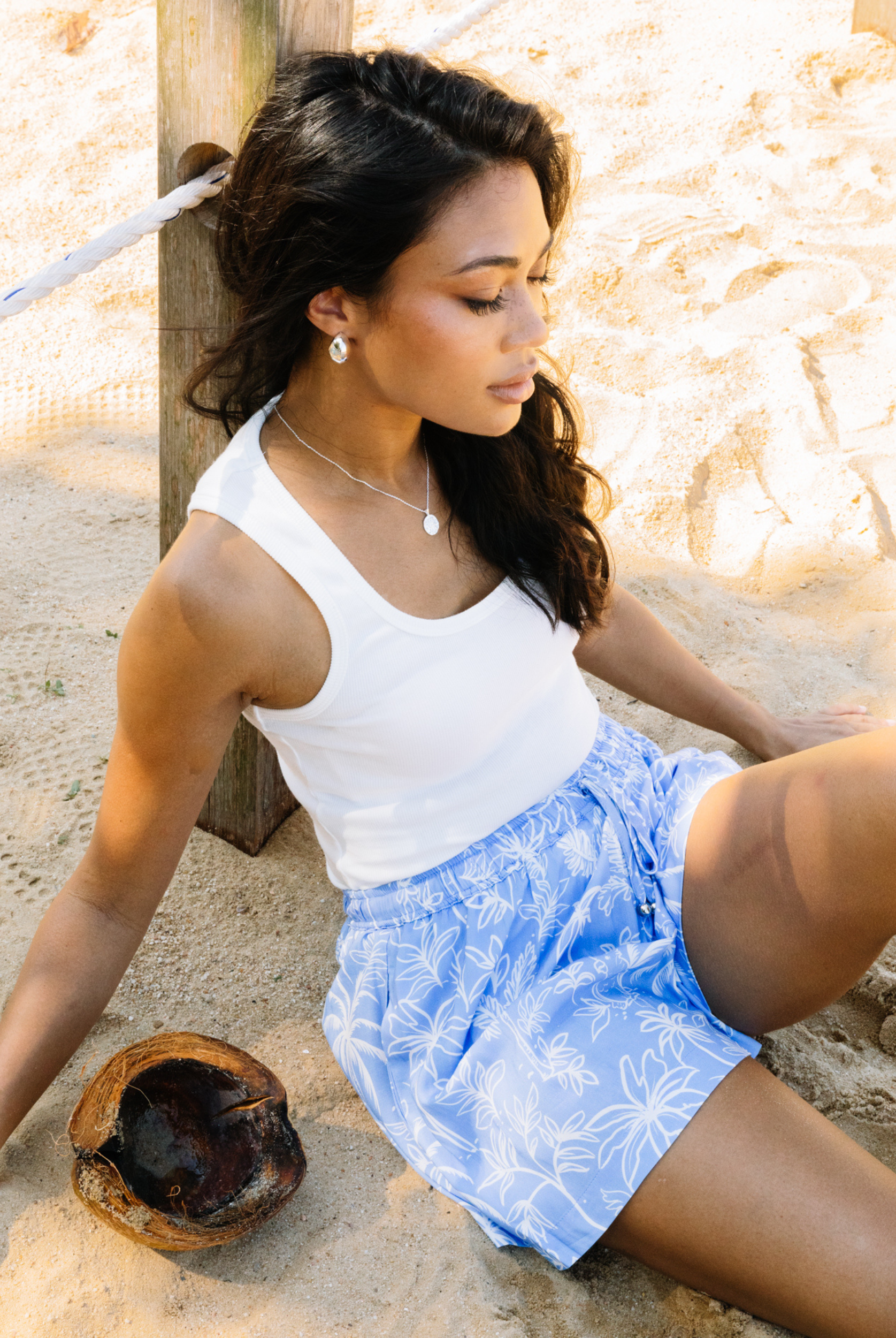 Woman wearing a white tank on the beach