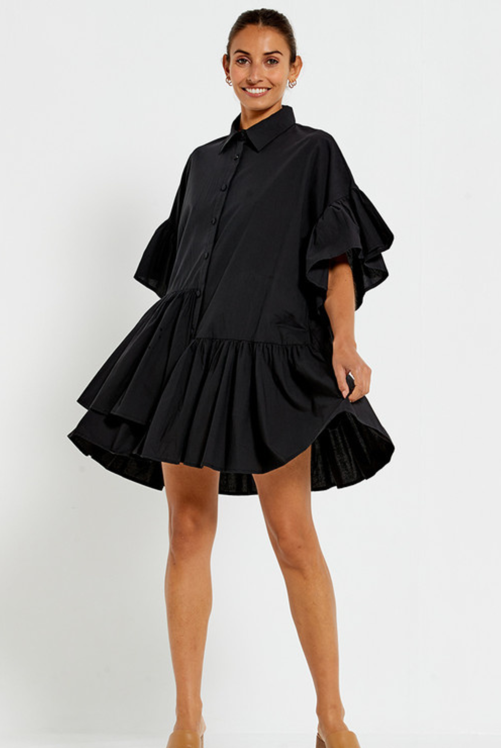 Model wearing the Bohemian Traders black Genoa Dress with button up front