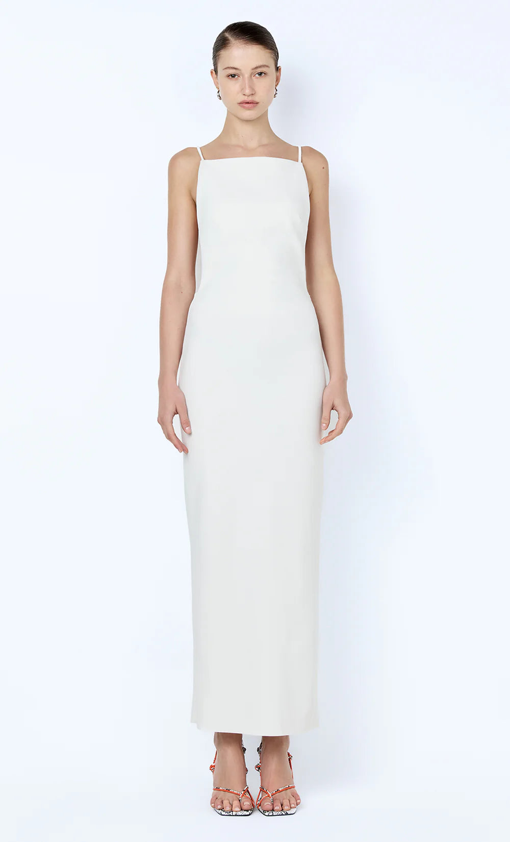 Woman wearing a white sleeveless dress on a white background