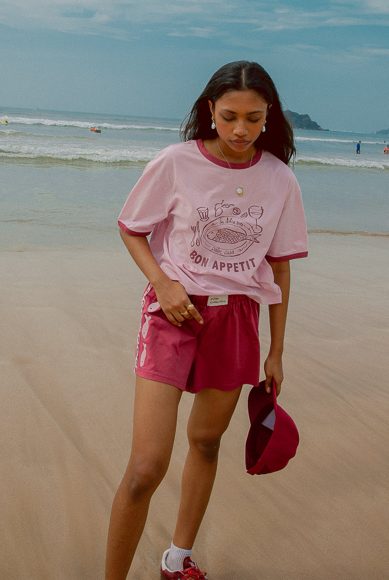Pink tee shot on a beach from Palm Collective