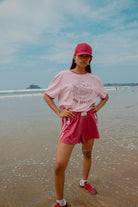 Pink tee shot on a beach from Palm Collective