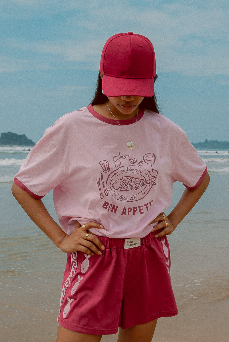 Pink tee shot on a beach from Palm Collective