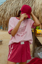 Pink tee shot on a beach from Palm Collective