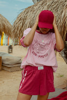Pink tee shot on a beach from Palm Collective