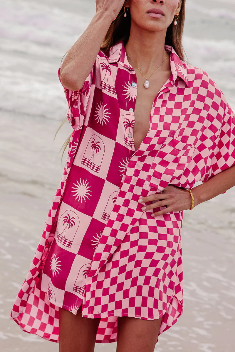 Woman wearing a pink and white patterned dress with a blurred background