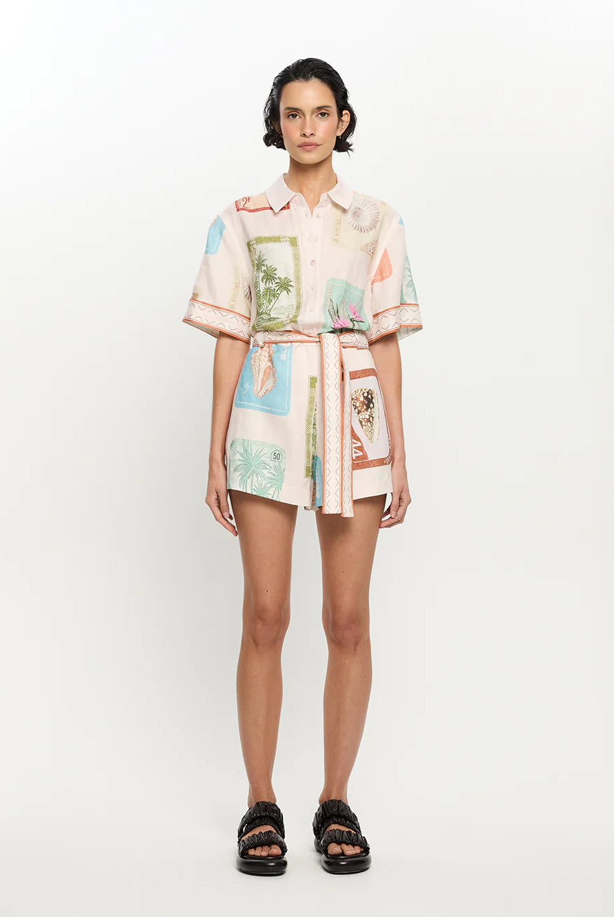 Model wearing a colorful patterned outfit on a white background