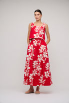 Woman wearing a red floral dress on a white background