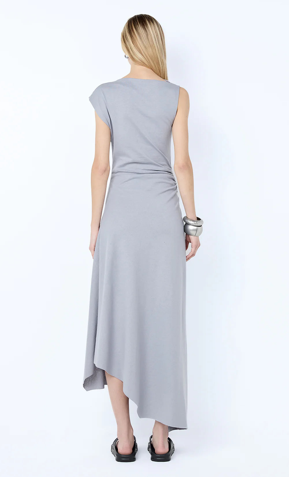 Woman wearing a light gray dress on a white background
