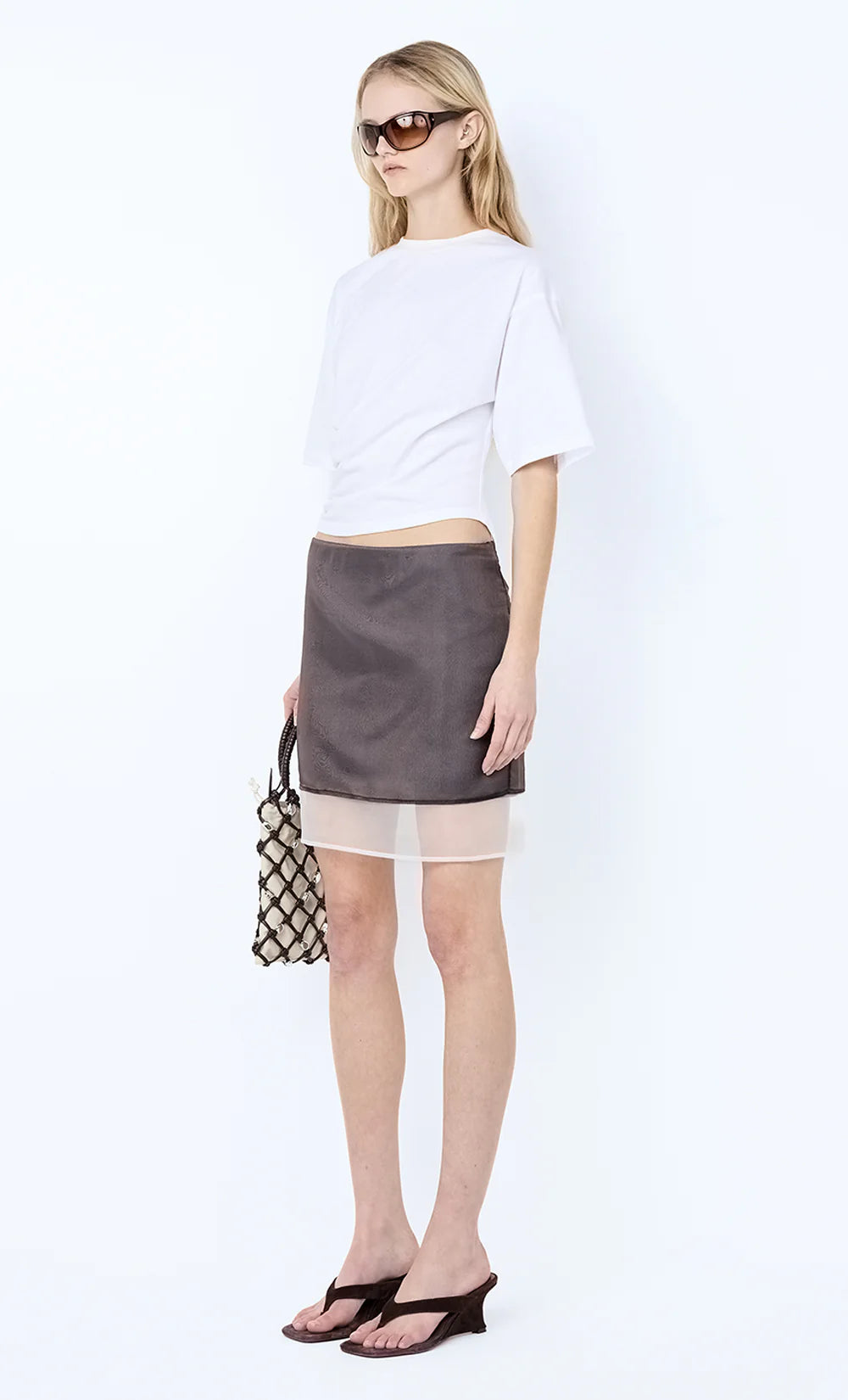 Woman wearing a white top and gray skirt with sunglasses on a white background Ema Asym Tee - Ivory