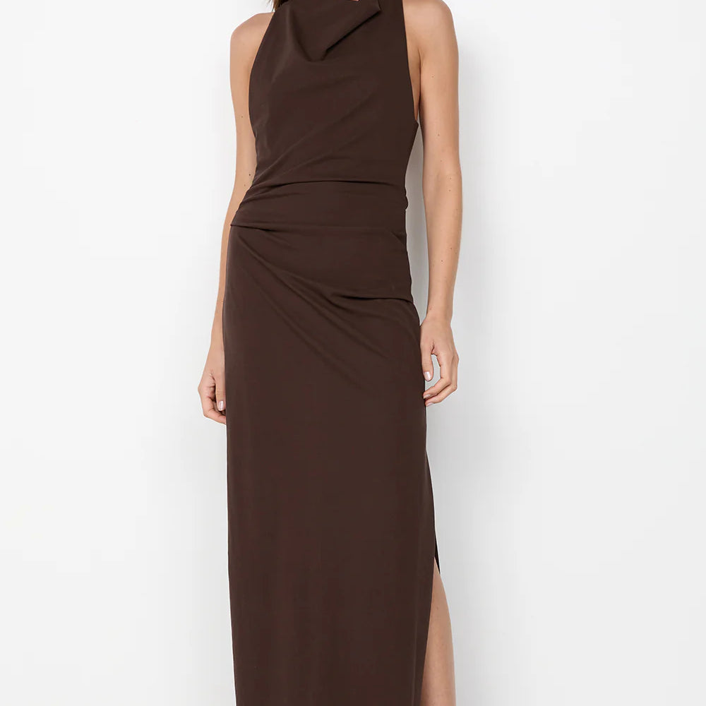 Woman wearing a brown sleeveless dress with a slit on a white background