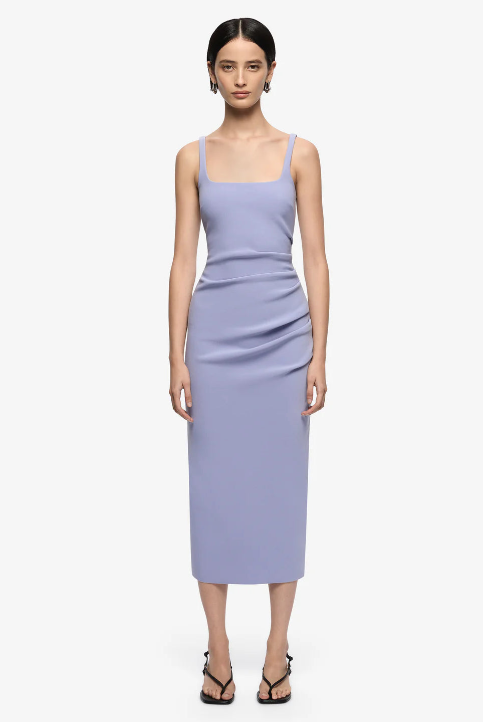 Woman wearing a light purple dress on a white background