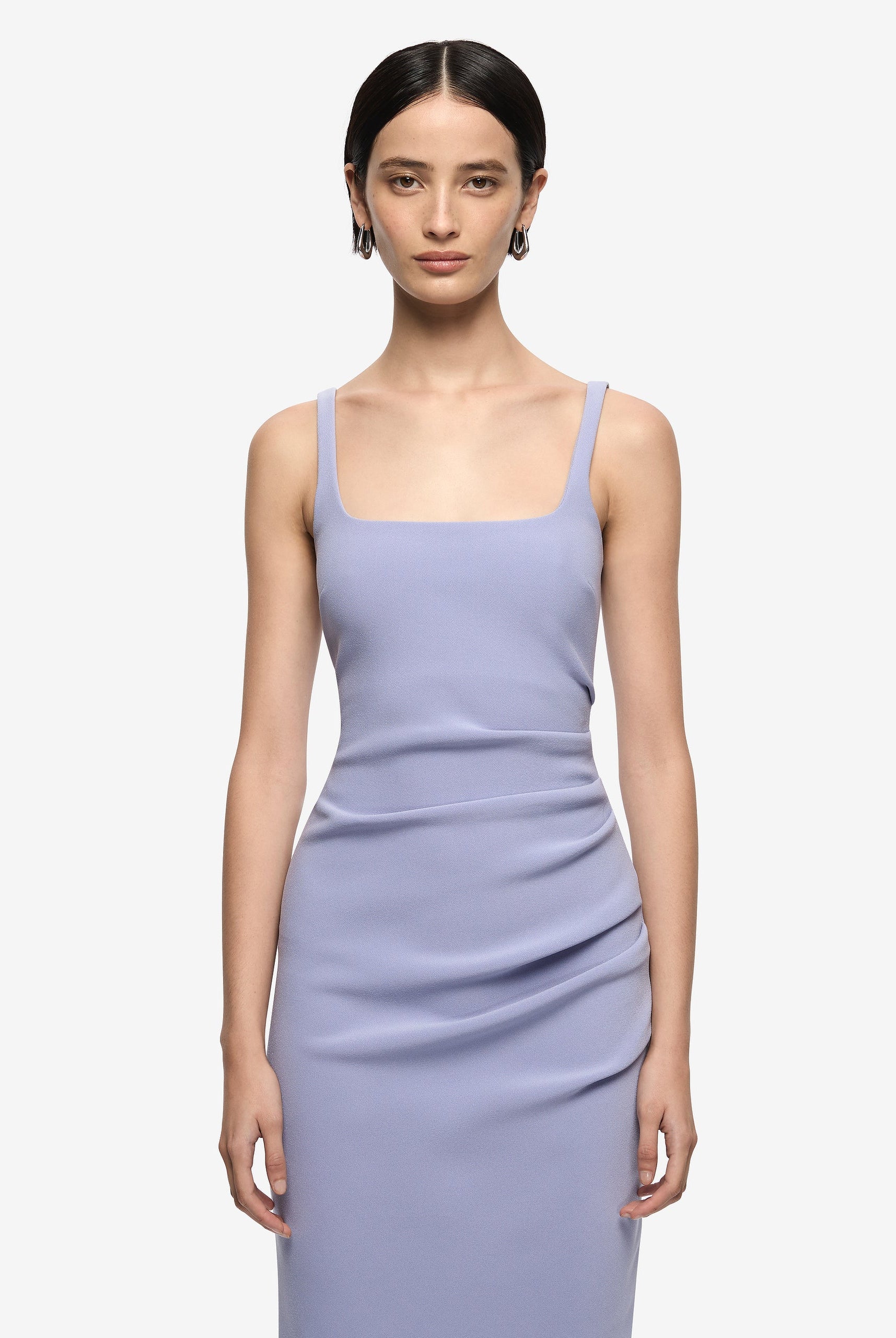 Woman wearing a light purple dress against a white background