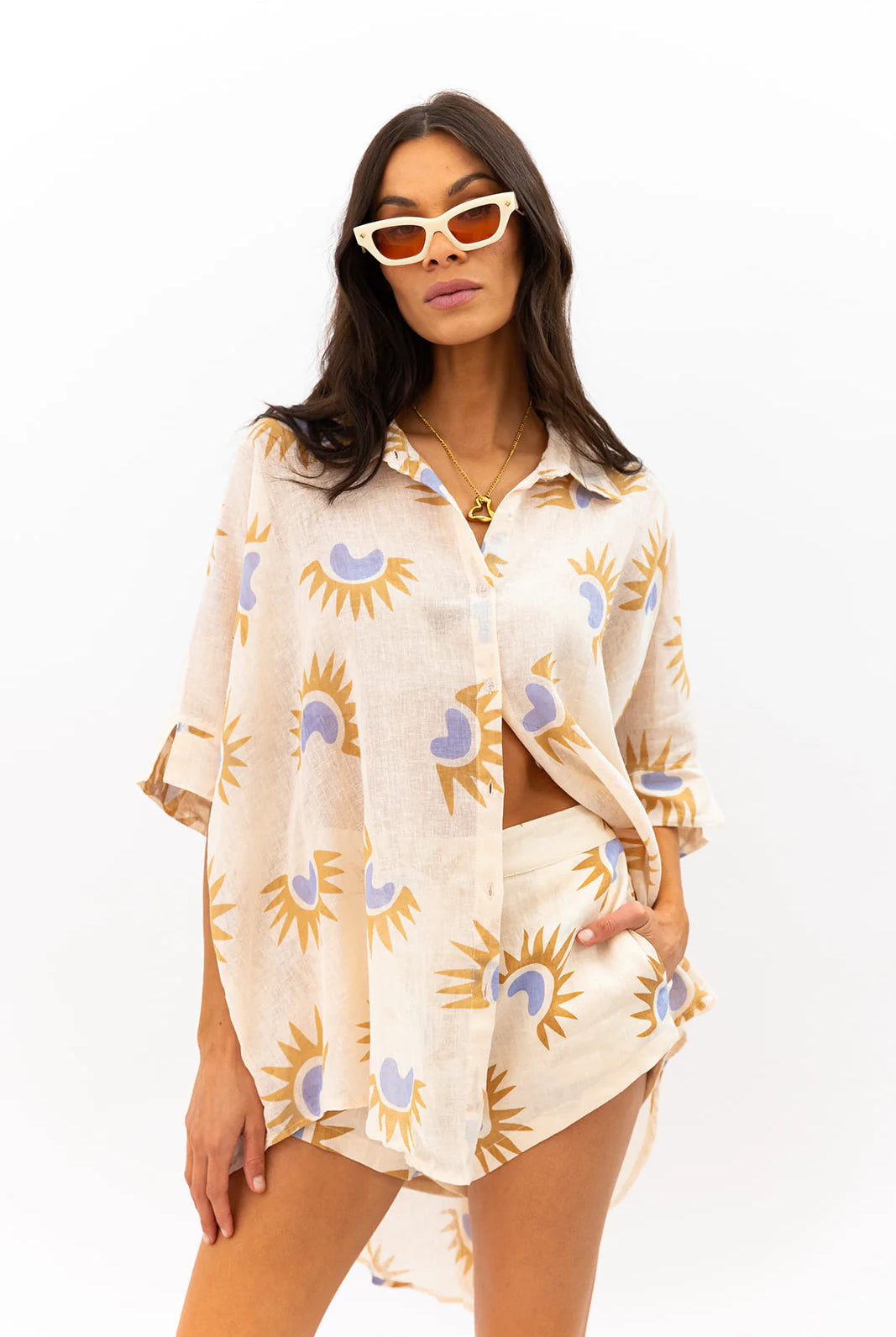 Woman wearing a patterned beige cover-up on a white background