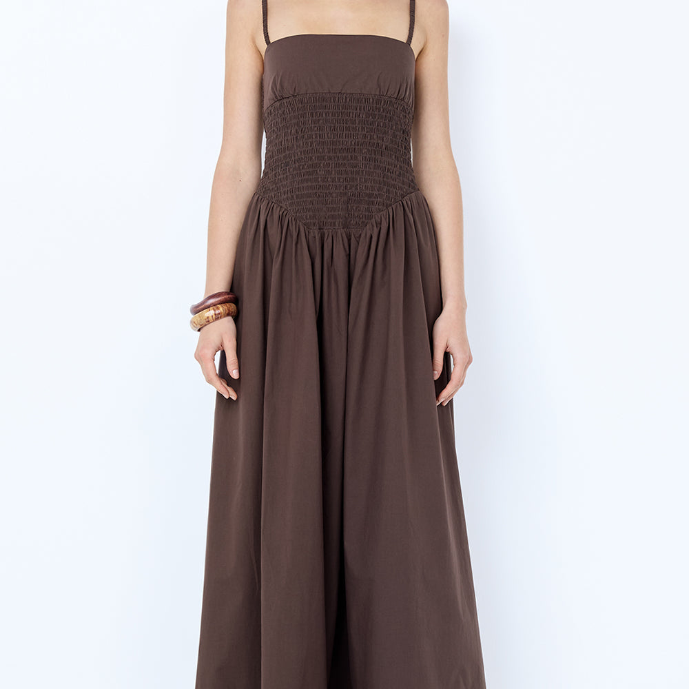 Woman wearing a brown sleeveless dress on a white background