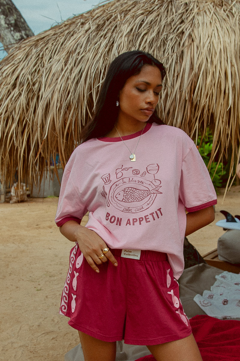 Pink tee shot on a beach from Palm Collective