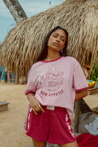 Pink tee shot on a beach from Palm Collective