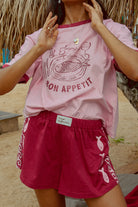 Pink tee shot on a beach from Palm Collective