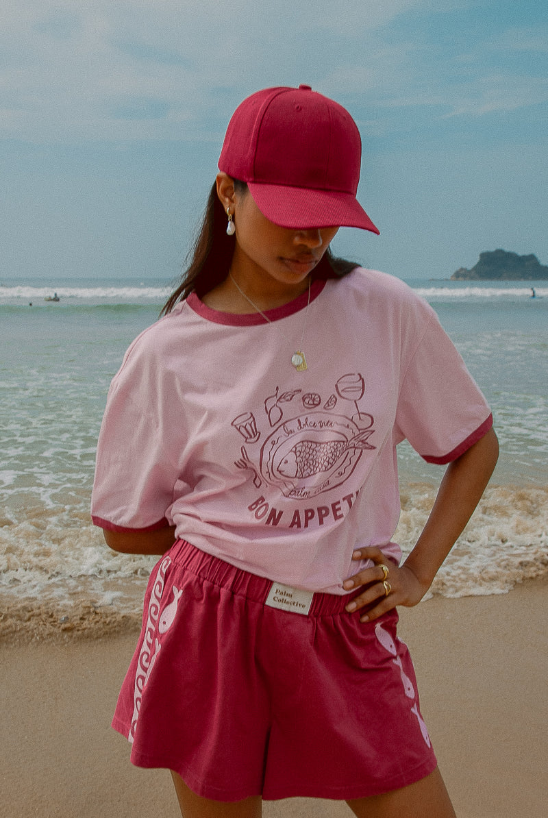 Pink tee shot on a beach from Palm Collective