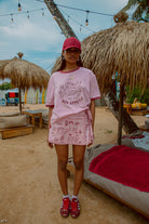 Pink tee shot on a beach from Palm Collective