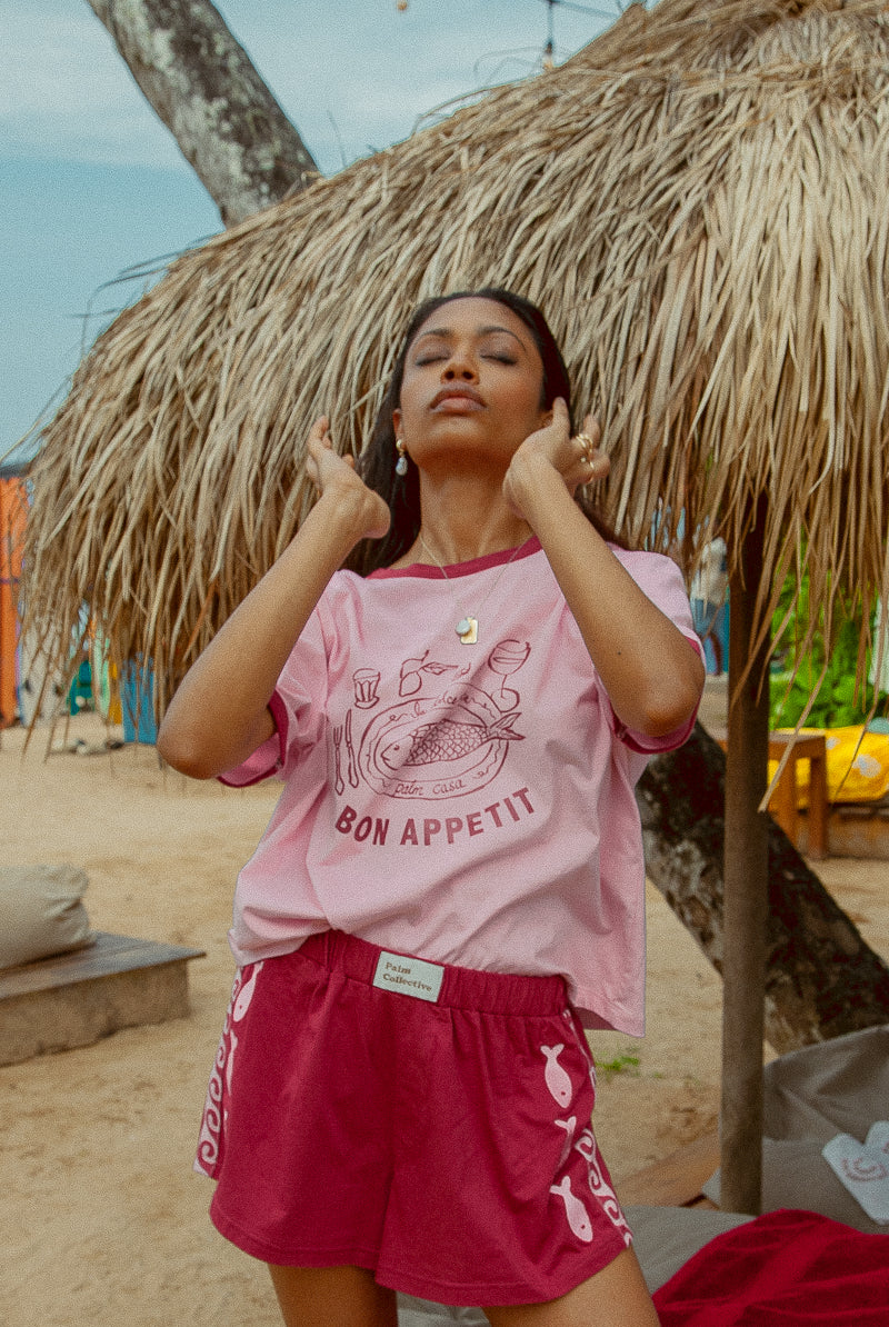 Pink tee shot on a beach from Palm Collective