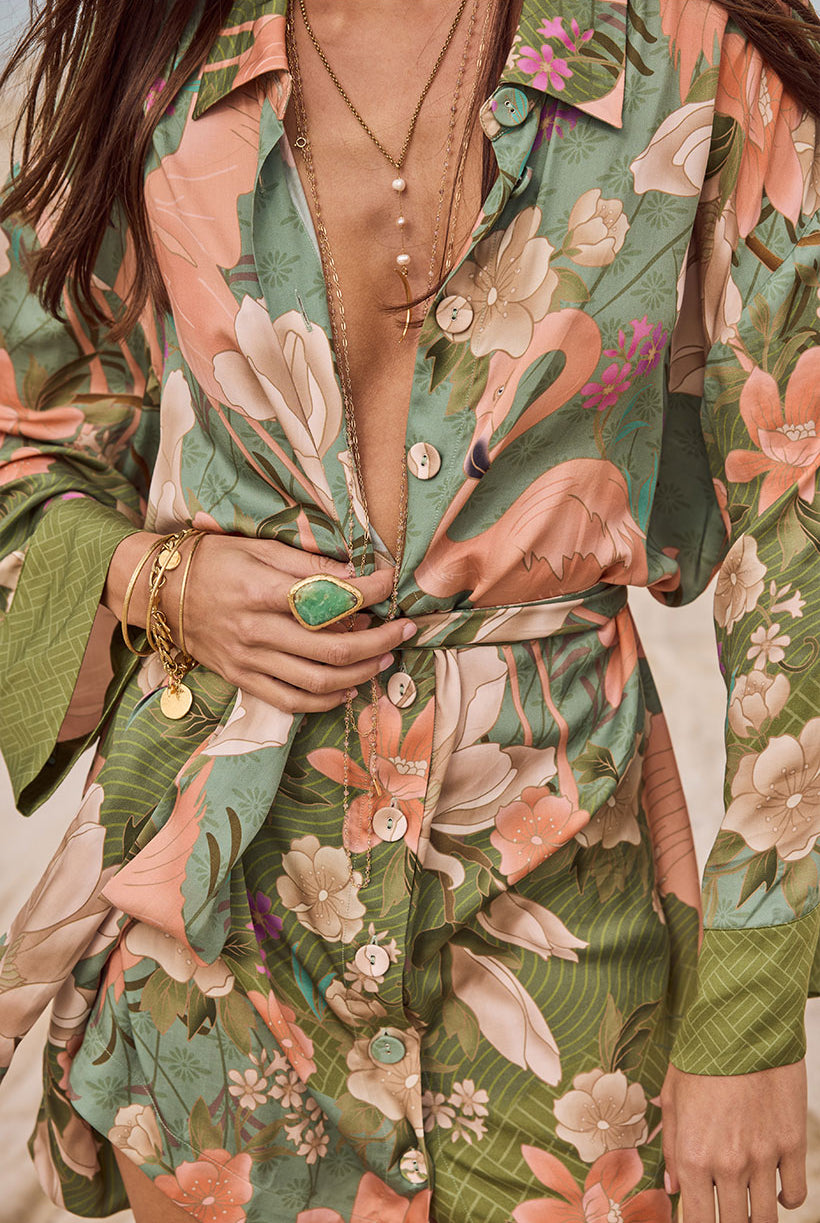 Person wearing a floral patterned outfit with a focus on the clothing design.