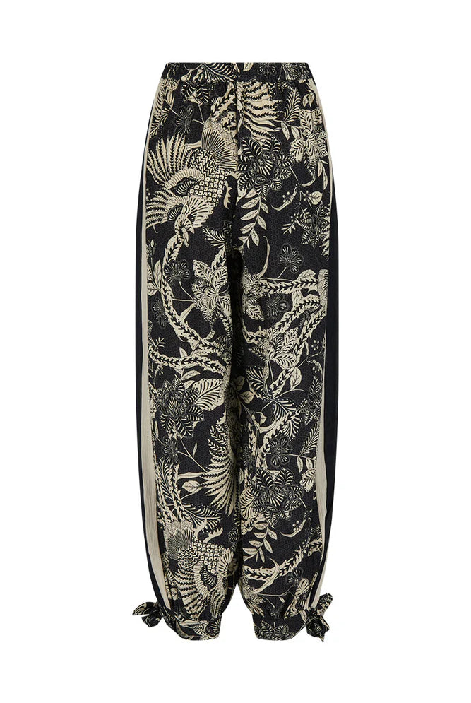 Tropical patterned pants on a white background