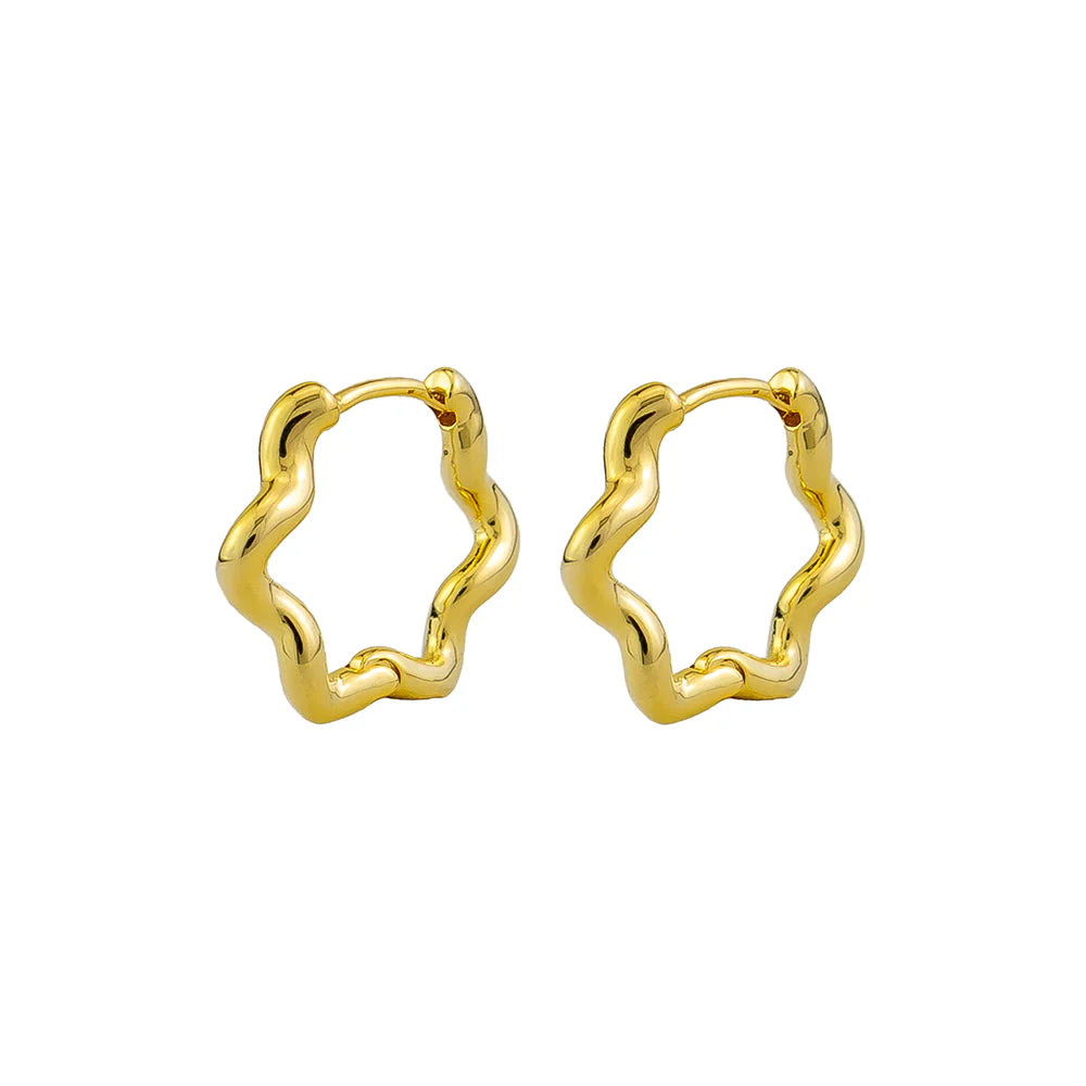 A pair of gold-colored hoop earrings with an organic curved shape.