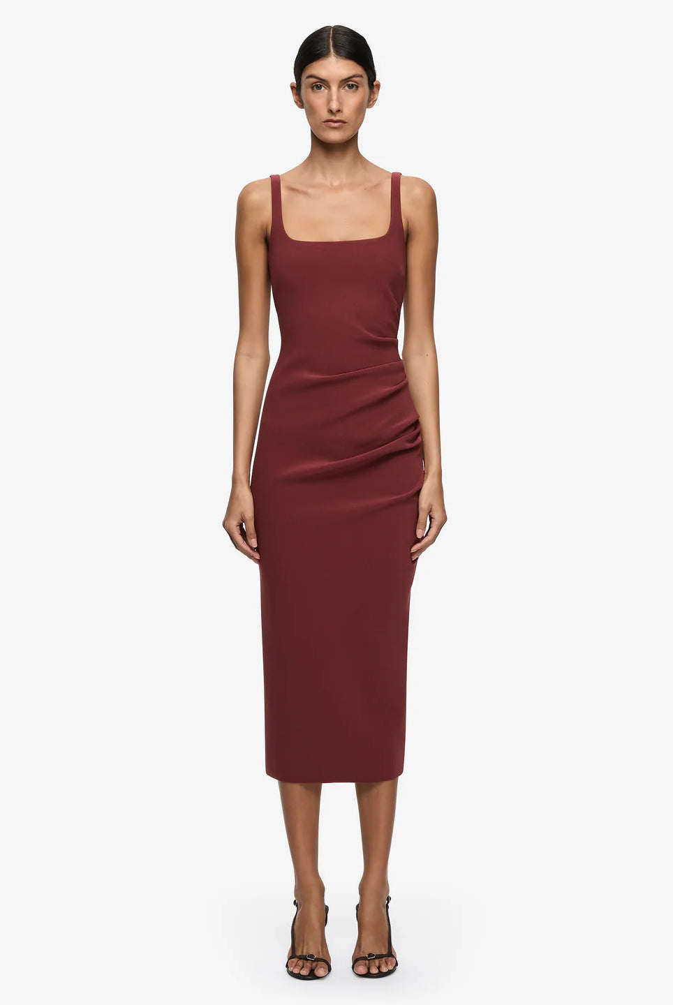 Woman wearing a burgundy dress on a white background