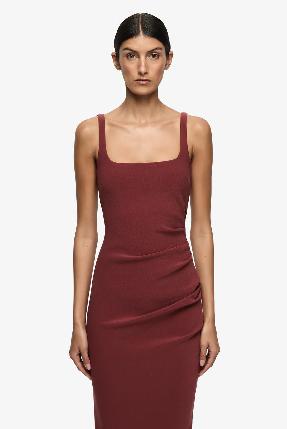 Woman wearing a burgundy dress on a white background