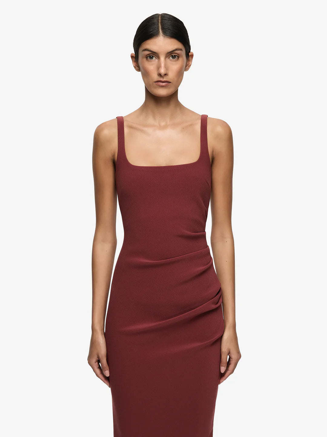 Woman wearing a burgundy dress on a white background