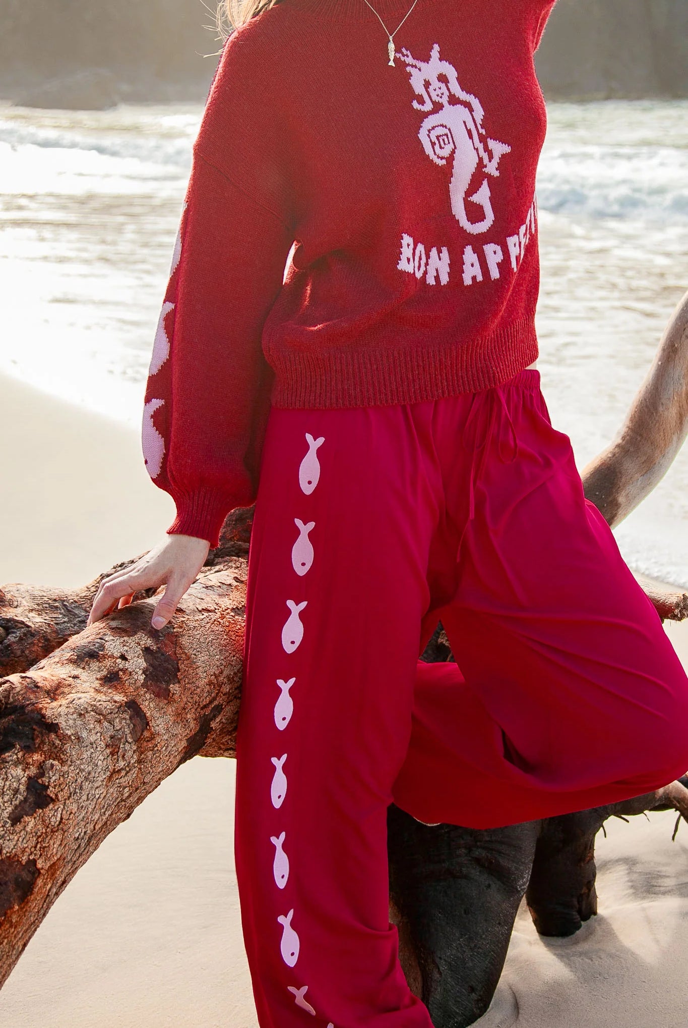 Deep red pants from Palm Collective with embroidered fish down the sides.