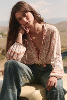 Sunshine Bandit Blouse in Desert Sage paired with blue wash jeans