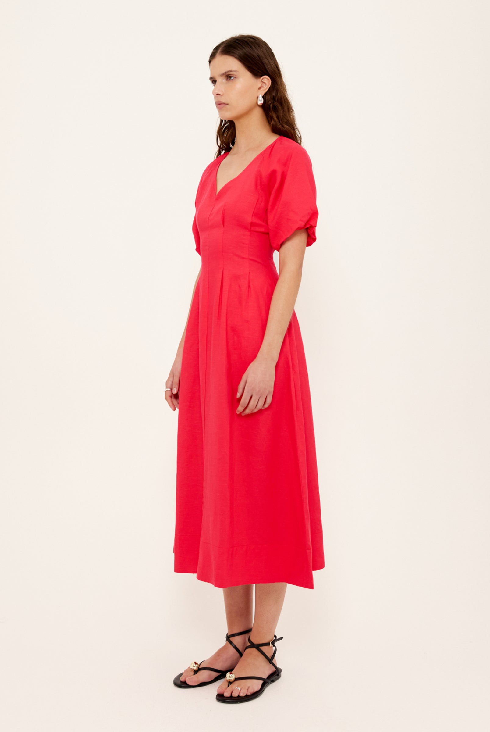 Woman wearing a red dress against a white background