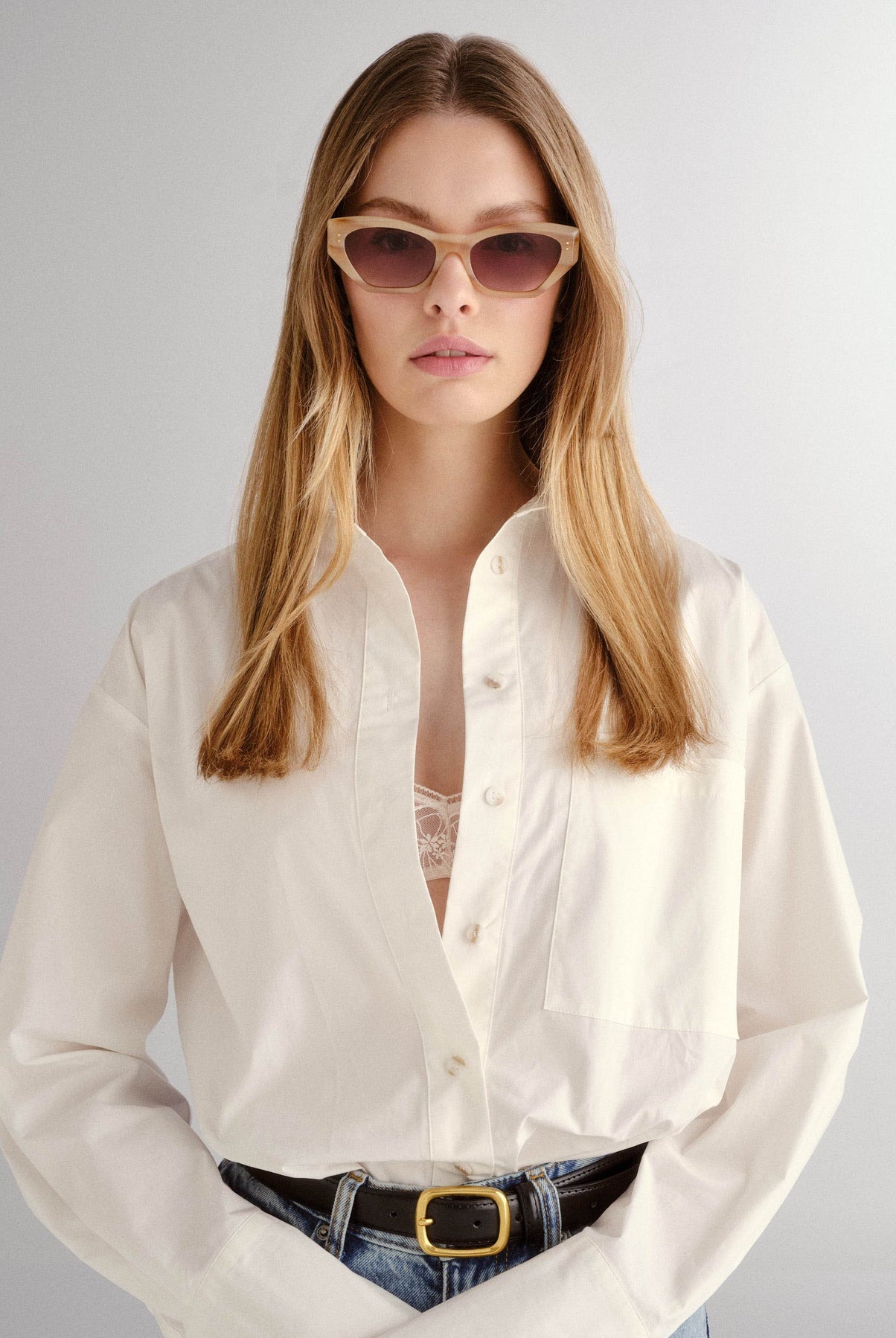 The Sydney Oat Sunglasses from Luv Lou worn by a blonde woman with white shirt