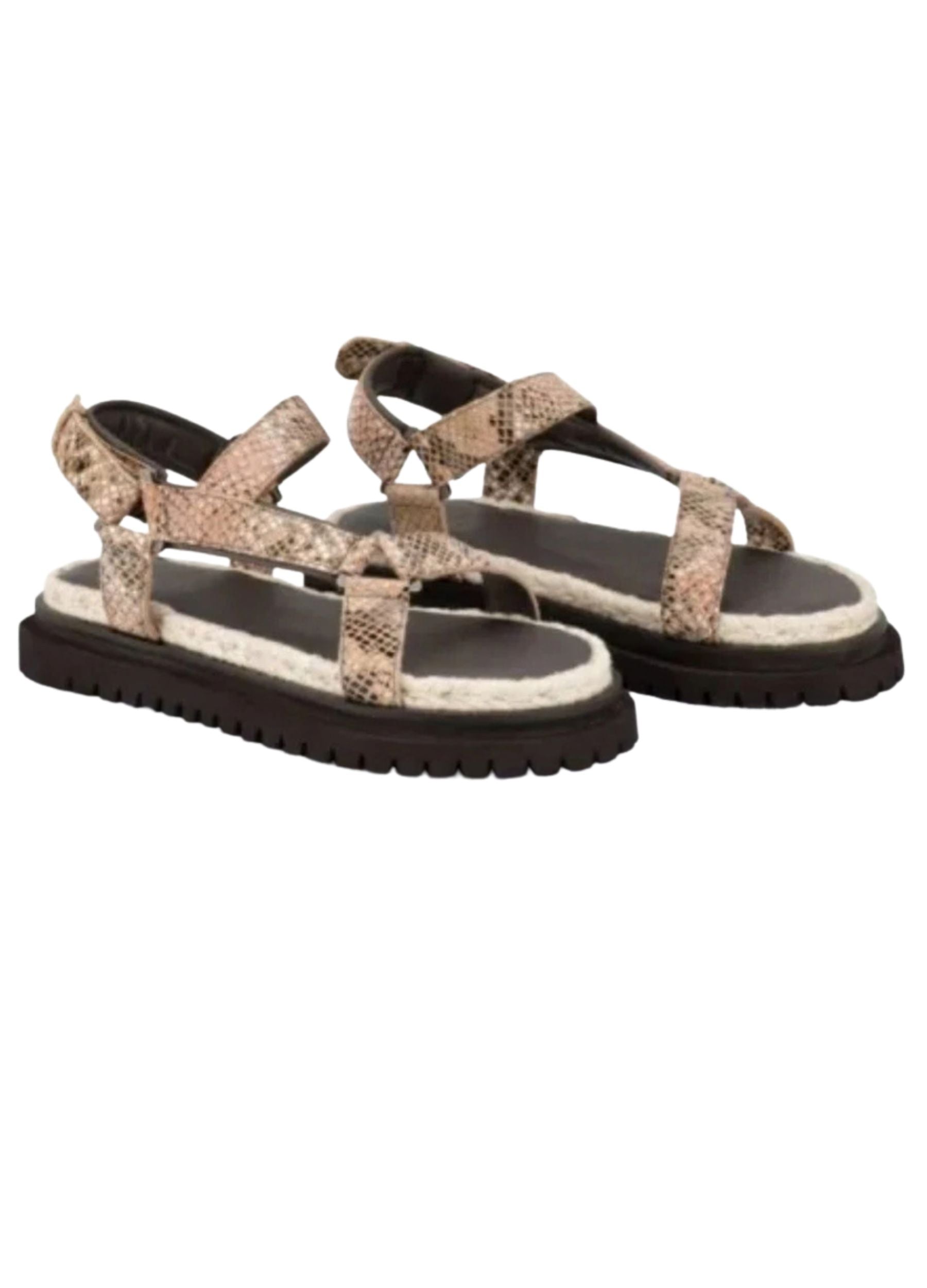Pair of sandals with snake print straps on a white background