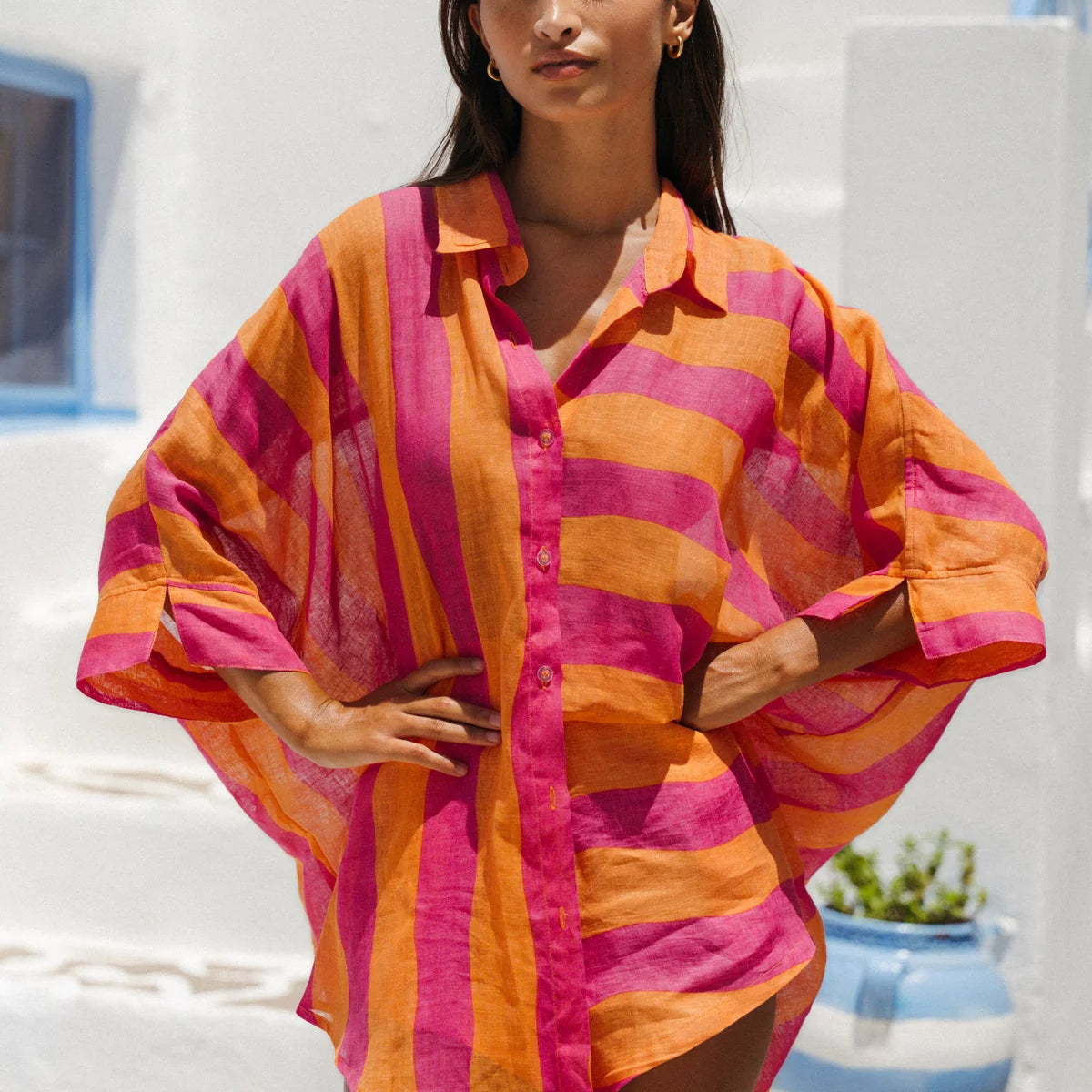 Woman wearing a colorful striped shirt in a Mediterranean setting