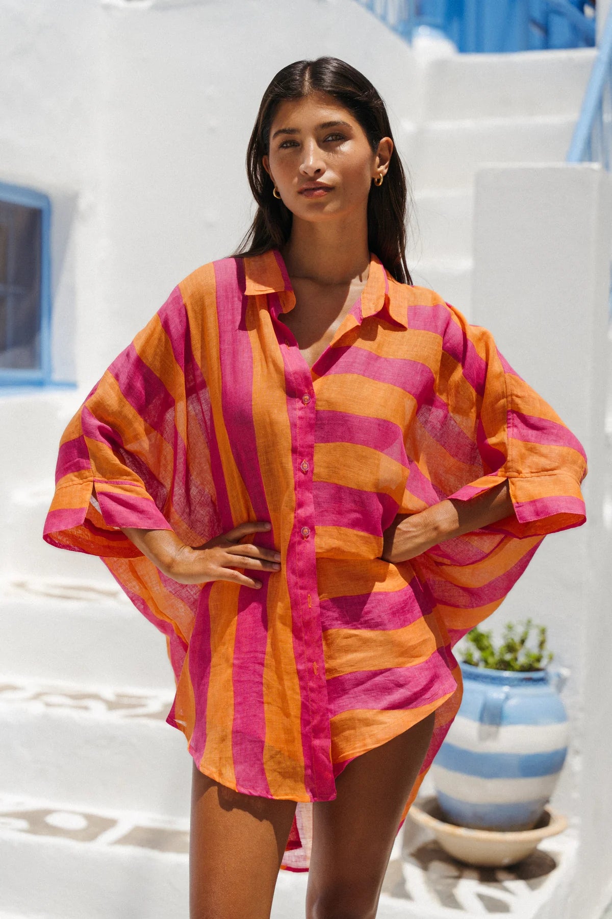 Woman wearing a colorful striped shirt in a Mediterranean setting