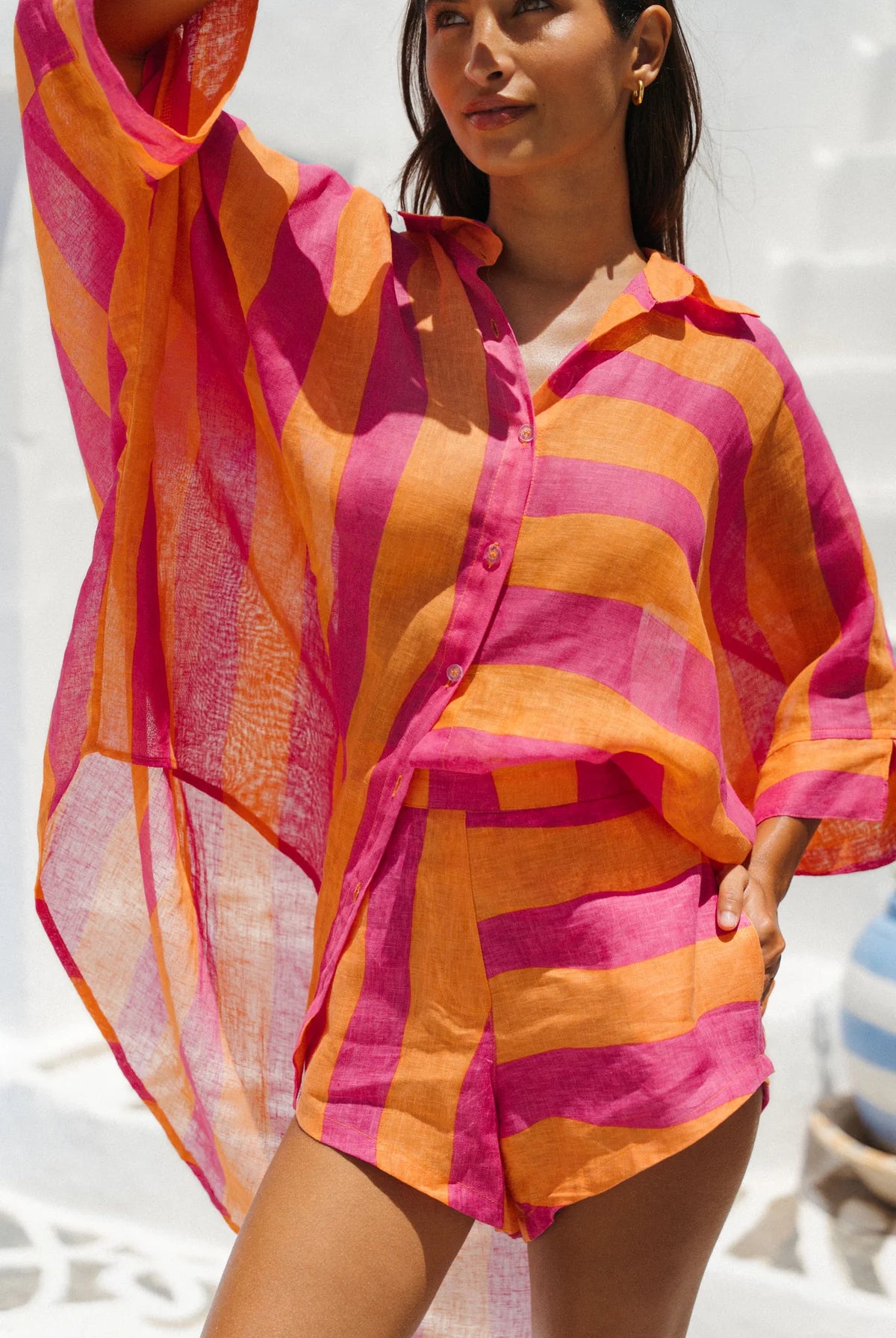 Woman wearing a colorful striped shirt on a beach