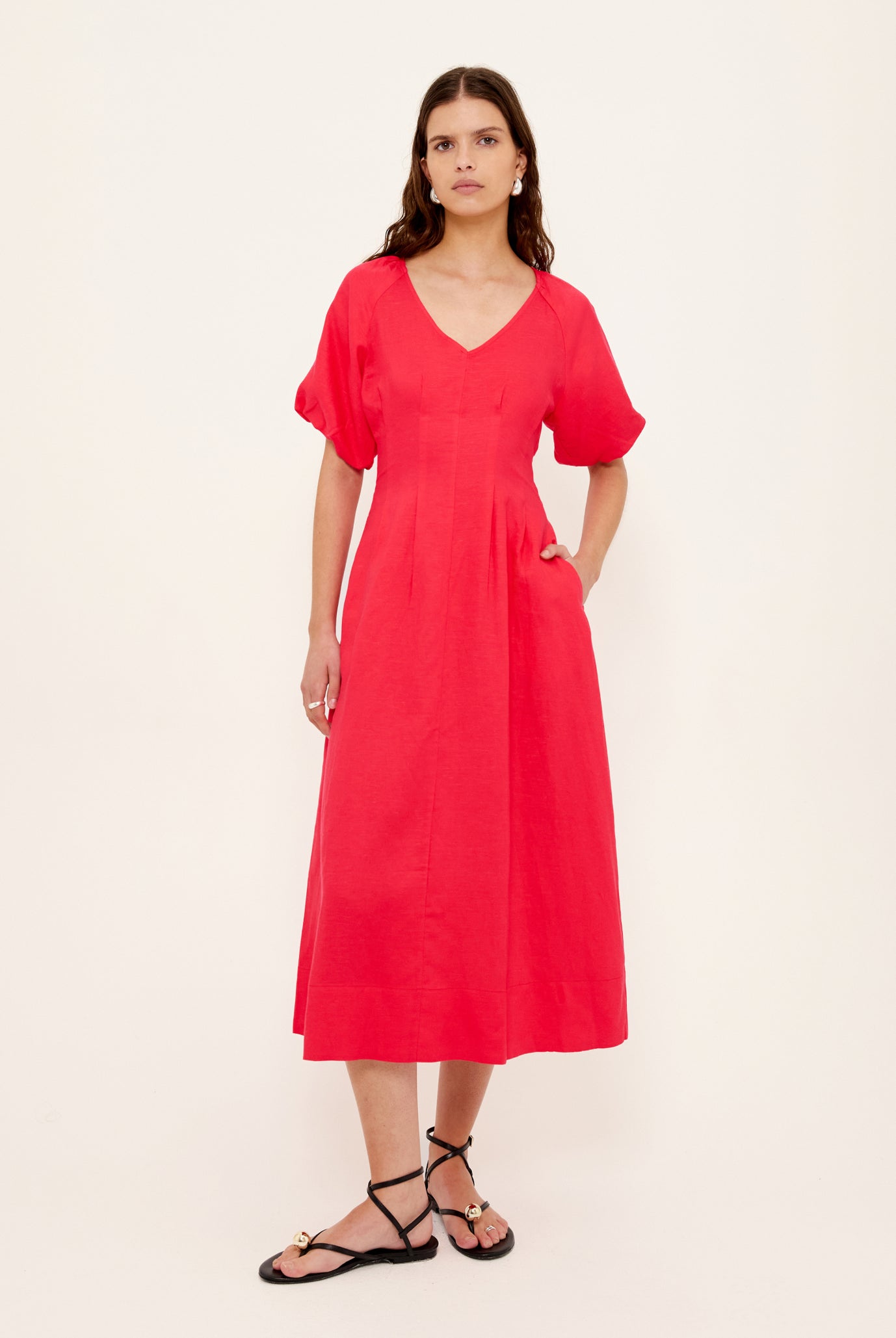 Woman wearing a red dress on a white background