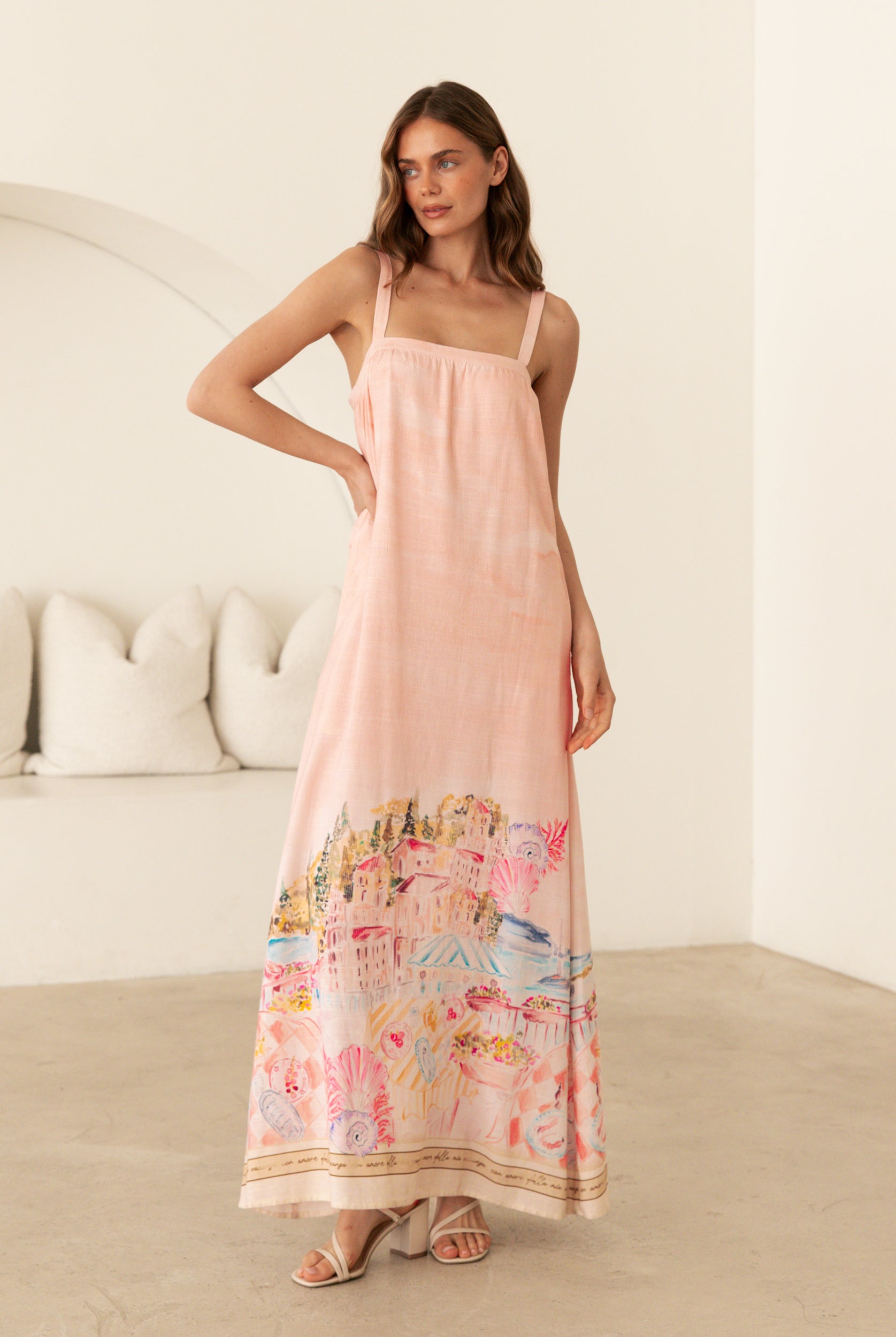 Ebby and I Luciana Maxi Dress worn by model on a white background. Coral placement print maxi with adjustable straps.